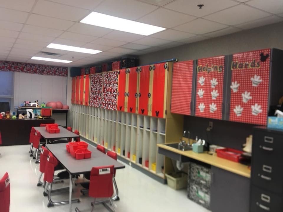 Red lockers with white polka dots and a Helping Hands board above them.