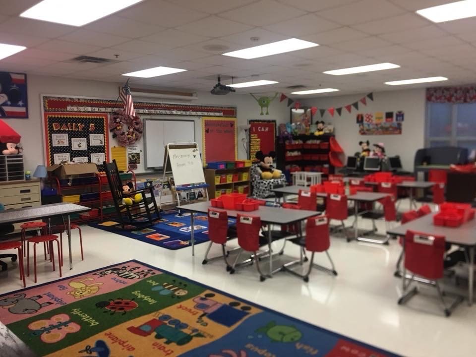 Mrs. George's first-grade classroom: red chairs, colorful rugs, bunting along the ceiling.